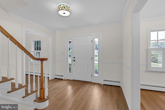 69 Hickory Ln, Chalfont, PA 18914 - entrance foyer featuring a baseboard heating unit, stairway, wood finished floors, and ornamental molding