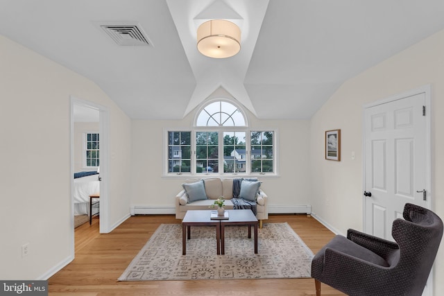 69 Hickory Ln, Chalfont, PA 18914 - living room with a baseboard radiator, light wood-type flooring, and lofted ceiling