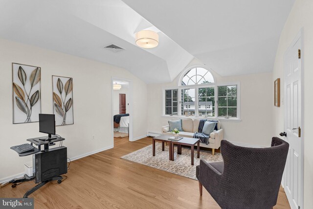 69 Hickory Ln, Chalfont, PA 18914 - sitting room featuring a baseboard radiator, light wood-style floors, and vaulted ceiling
