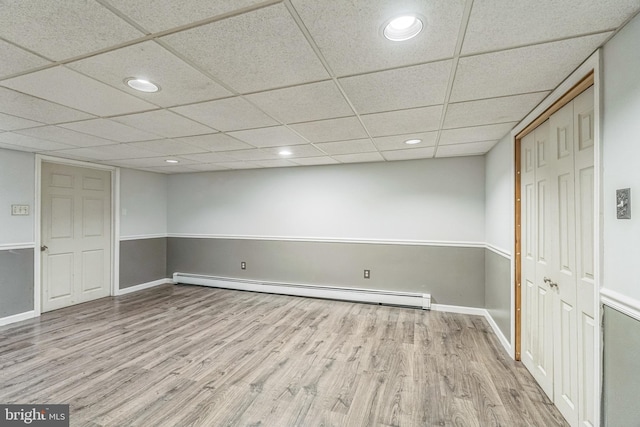 69 Hickory Ln, Chalfont, PA 18914 - finished below grade area with a baseboard heating unit, wood finished floors, a paneled ceiling, and recessed lighting
