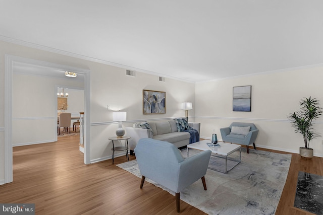 69 Hickory Ln, Chalfont, PA 18914 - living room with wood finished floors, a chandelier, and crown molding