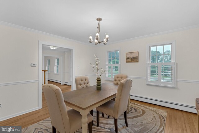 69 Hickory Ln, Chalfont, PA 18914 - dining area with baseboard heating, a chandelier, ornamental molding, and light wood-style floors