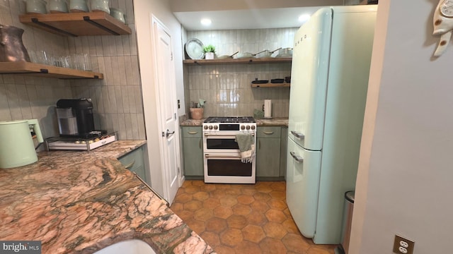 715 6th St NW Unit 1002, Washington, DC 20001 - kitchen with freestanding refrigerator, range with gas stovetop, open shelves, backsplash, and recessed lighting