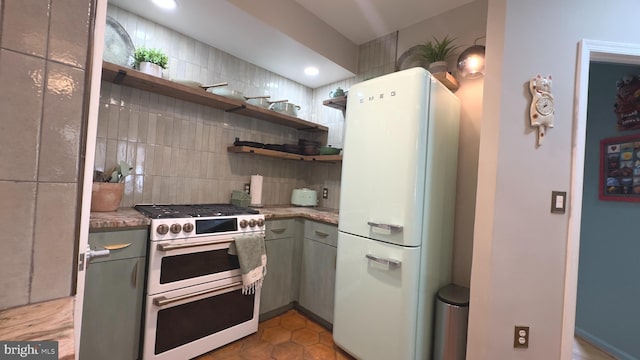 715 6th St NW Unit 1002, Washington, DC 20001 - kitchen with freestanding refrigerator, double oven range, open shelves, tasteful backsplash, and gray cabinetry