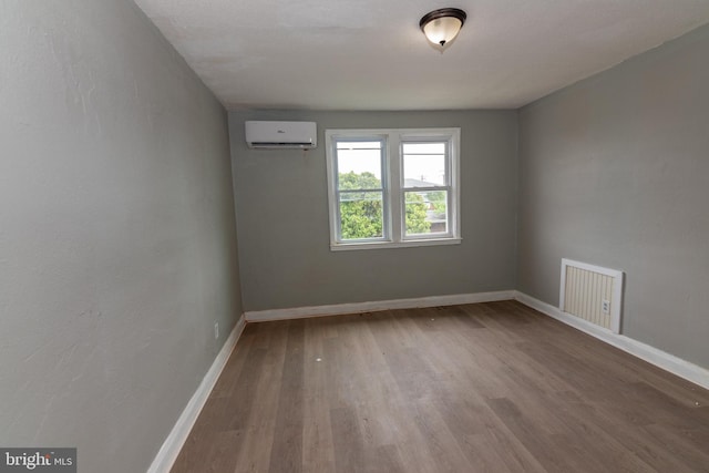 1304 N Linwood Ave, Baltimore, MD 21213 - empty room featuring an AC wall unit and wood finished floors