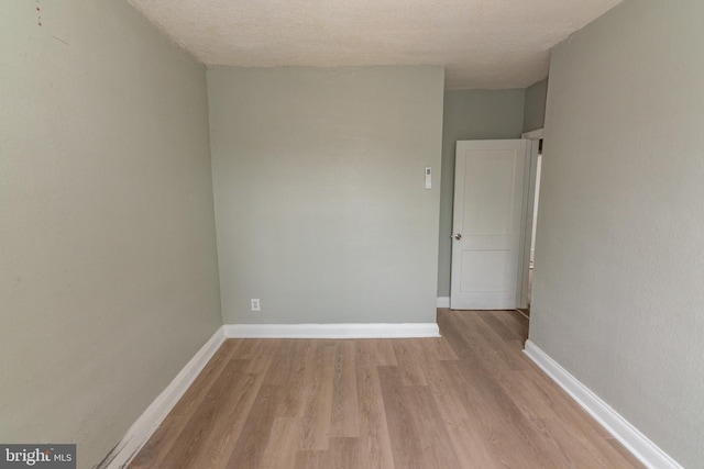 1304 N Linwood Ave, Baltimore, MD 21213 - empty room with light wood-type flooring and a textured ceiling