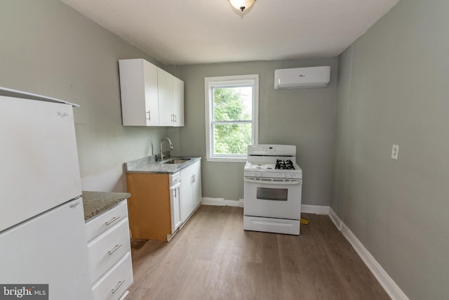 1304 N Linwood Ave, Baltimore, MD 21213 - kitchen with white appliances, a wall mounted air conditioner, light wood finished floors, and white cabinetry