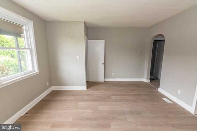 1304 N Linwood Ave, Baltimore, MD 21213 - unfurnished room with arched walkways and light wood-type flooring