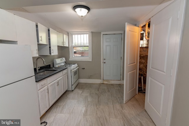 1304 N Linwood Ave, Baltimore, MD 21213 - kitchen featuring white appliances, white cabinets, and dark countertops