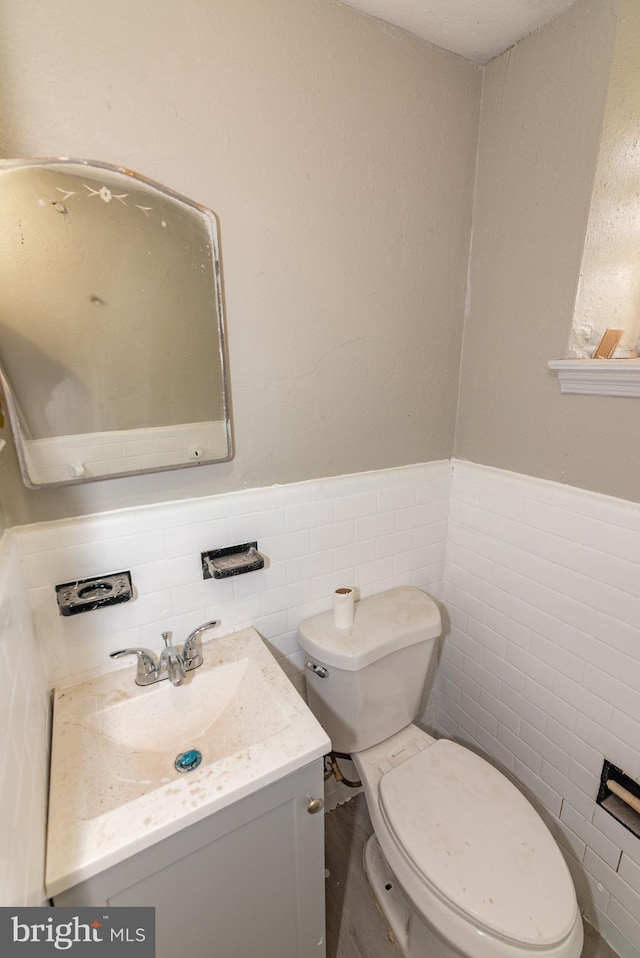 1304 N Linwood Ave, Baltimore, MD 21213 - half bath featuring vanity, tile walls, and wainscoting