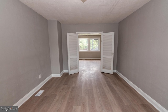1304 N Linwood Ave, Baltimore, MD 21213 - hall featuring wood finished floors and a textured ceiling