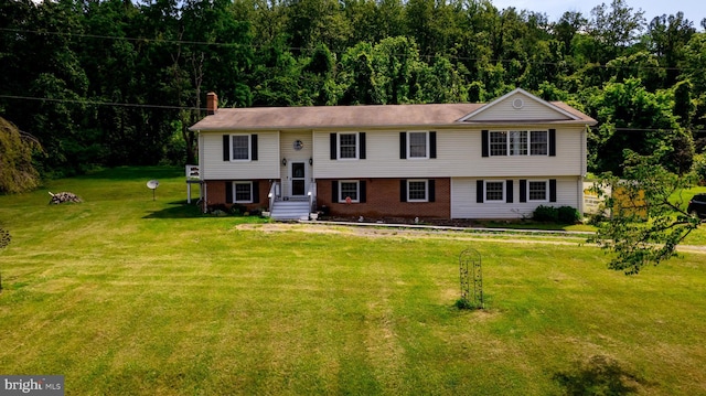 4179 Fiery Run Rd, Linden, VA 22642 - split foyer home featuring a chimney, a front lawn, brick siding, and a wooded view