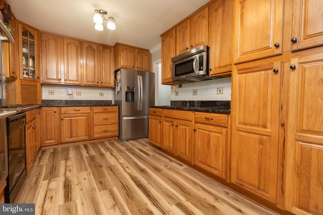 4179 Fiery Run Rd, Linden, VA 22642 - kitchen with black appliances, light wood-type flooring, decorative backsplash, and brown cabinets