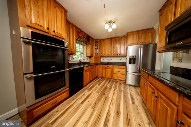 4179 Fiery Run Rd, Linden, VA 22642 - kitchen with black appliances, brown cabinets, light wood finished floors, and glass insert cabinets