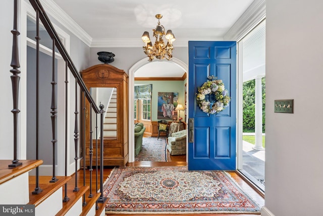 3201/2 Mansion Dr, Alexandria, VA 22302 - entryway featuring crown molding, arched walkways, plenty of natural light, a chandelier, and stairs