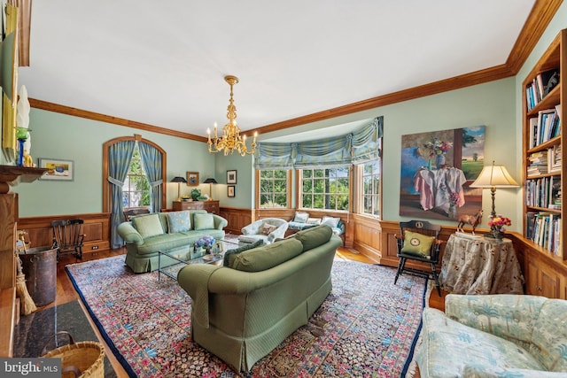 3201/2 Mansion Dr, Alexandria, VA 22302 - living room featuring a wainscoted wall, wood finished floors, healthy amount of natural light, crown molding, and a chandelier