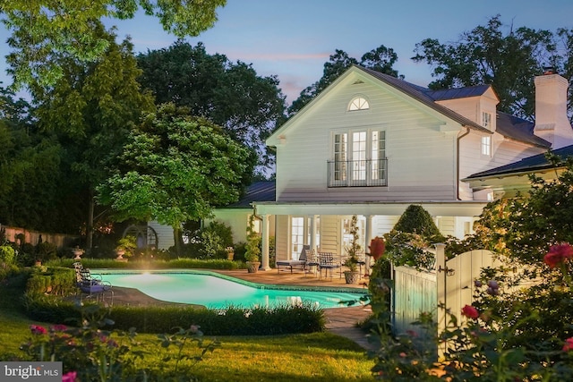 3201/2 Mansion Dr, Alexandria, VA 22302 - back of house with an outdoor pool, french doors, and a patio