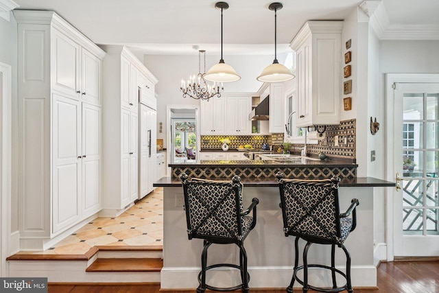 3201/2 Mansion Dr, Alexandria, VA 22302 - kitchen with a peninsula, dark countertops, backsplash, and white cabinetry