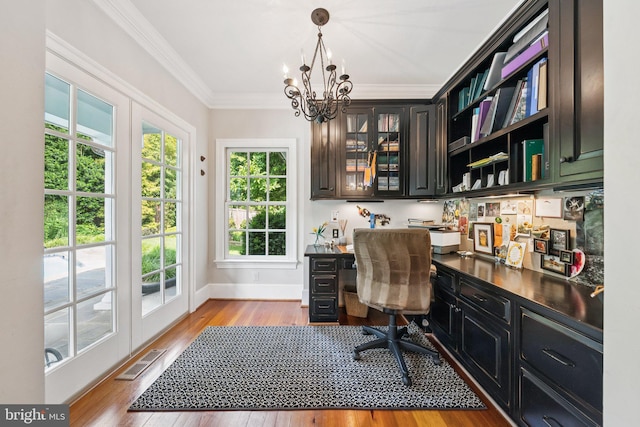 3201/2 Mansion Dr, Alexandria, VA 22302 - office space with built in desk, a chandelier, wood finished floors, and crown molding