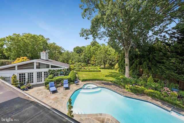3201/2 Mansion Dr, Alexandria, VA 22302 - view of pool featuring french doors, a patio area, a lawn, a pool with connected hot tub, and view of wooded area