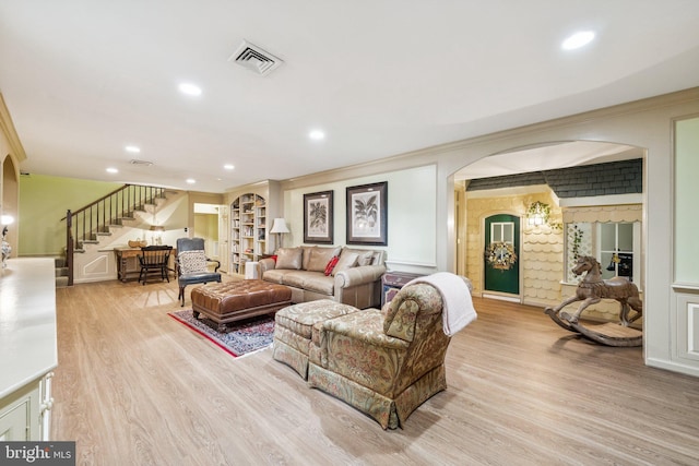 3201/2 Mansion Dr, Alexandria, VA 22302 - living area with stairway, arched walkways, light wood-style floors, ornamental molding, and recessed lighting