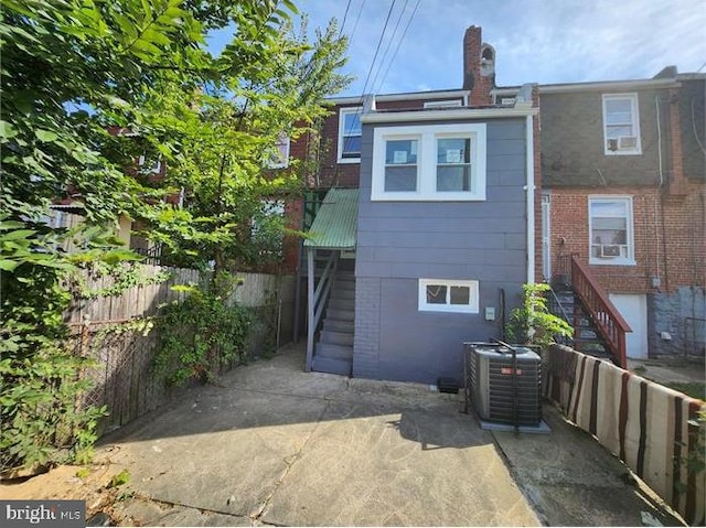 3322 Elmora Ave, Baltimore, MD 21213 - rear view of property with stairs and a chimney