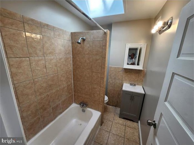 3322 Elmora Ave, Baltimore, MD 21213 - bathroom with vanity, tile walls, tile patterned floors, shower / bathtub combination, and a skylight