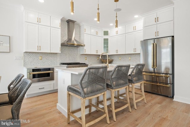 1 Capstan Rd, Waretown, NJ 08758 - kitchen with stainless steel appliances, wall chimney exhaust hood, light countertops, light wood-type flooring, and recessed lighting