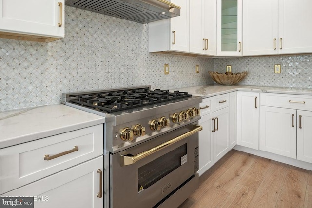 1 Capstan Rd, Waretown, NJ 08758 - kitchen featuring high end stove, premium range hood, white cabinets, light wood-style flooring, and backsplash