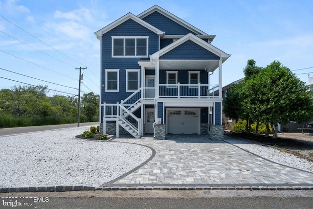 1 Capstan Rd, Waretown, NJ 08758 - raised beach house with stairway, decorative driveway, a garage, a porch, and stone siding