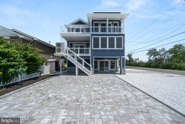 1 Capstan Rd, Waretown, NJ 08758 - raised beach house with a balcony, stairs, decorative driveway, and a storage shed