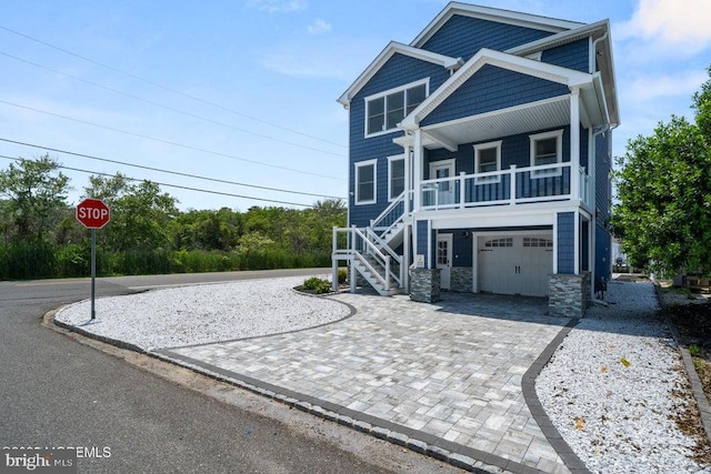 1 Capstan Rd, Waretown, NJ 08758 - beach home featuring covered porch, stairs, decorative driveway, an attached garage, and stone siding