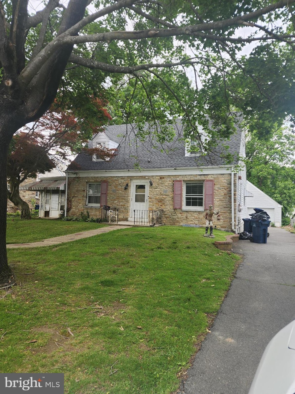 150 Gainsboro Rd, Trenton, NJ 08648 - cape cod-style house featuring stone siding, a front lawn, and a detached garage