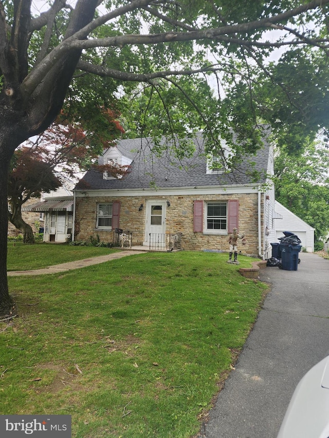 150 Gainsboro Rd, Trenton, NJ 08648 - cape cod-style house featuring stone siding, a front lawn, and a detached garage