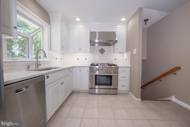 13 Bryan Ave, Malvern, PA 19355 - kitchen featuring stainless steel appliances, wall chimney exhaust hood, backsplash, light tile patterned floors, and recessed lighting