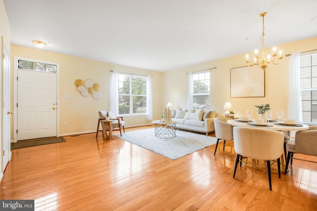20114 Gunners Ter, Germantown, MD 20876 - living room with a chandelier and light wood finished floors