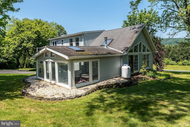 2462 Route Unit 412, Hellertown, PA 18055 - back of house with a sunroom, a shingled roof, and a lawn