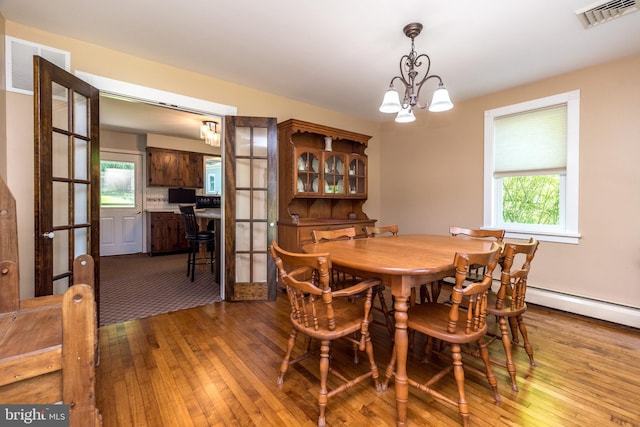 2462 Route Unit 412, Hellertown, PA 18055 - dining area with hardwood / wood-style flooring, healthy amount of natural light, and a chandelier