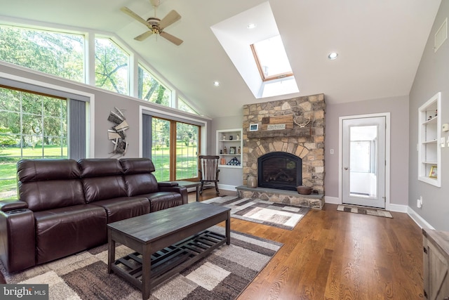 2462 Route Unit 412, Hellertown, PA 18055 - living room with built in features, a ceiling fan, a fireplace, a skylight, and wood finished floors
