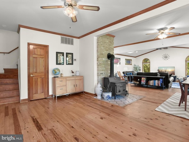 13310 Mockingbird Ln, Bowie, MD 20720 - living area featuring a ceiling fan, hardwood / wood-style floors, stairway, a wood stove, and vaulted ceiling