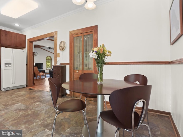 13310 Mockingbird Ln, Bowie, MD 20720 - dining room featuring ornamental molding, stone finish flooring, and a wainscoted wall