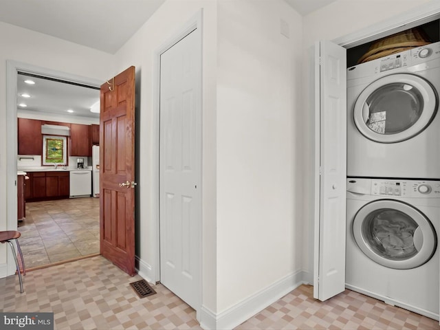13310 Mockingbird Ln, Bowie, MD 20720 - laundry room with stacked washer / drying machine, recessed lighting, and light flooring
