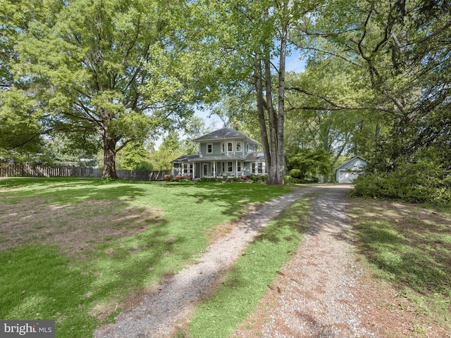 13310 Mockingbird Ln, Bowie, MD 20720 - view of front of property with an outdoor structure, a garage, dirt driveway, and covered porch