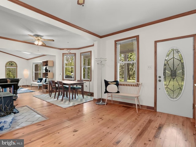 13310 Mockingbird Ln, Bowie, MD 20720 - entrance foyer with light wood-type flooring, ceiling fan, a wood stove, and crown molding