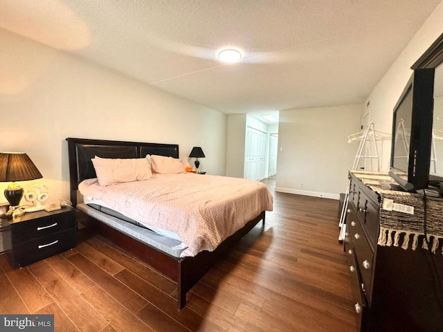 20822 Valley Forge Cir Unit 822, King Of Prussia, PA 19406 - bedroom featuring dark wood-style flooring, a textured ceiling, and a closet