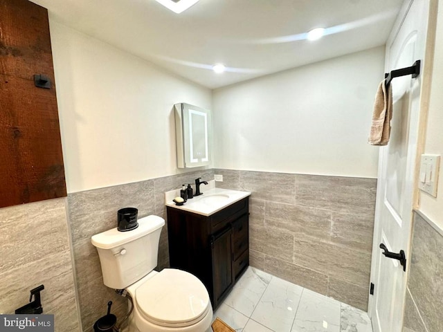 20822 Valley Forge Cir Unit 822, King Of Prussia, PA 19406 - bathroom with tile walls, vanity, marble look tile flooring, and a wainscoted wall