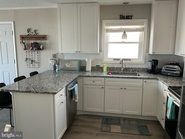 708 Bradley Rd Unit B, Ocean City, MD 21842 - kitchen with a peninsula, stainless steel appliances, white cabinetry, decorative backsplash, and crown molding