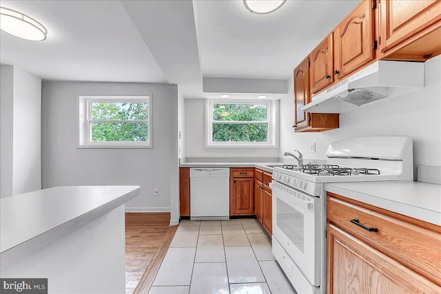 747 Bennington Rd, Folcroft, PA 19032 - kitchen with white appliances, under cabinet range hood, light countertops, and healthy amount of natural light