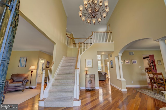18 Knottingham Dr, Voorhees, NJ 08043 - foyer with wood finished floors, a high ceiling, ornate columns, stairway, and arched walkways
