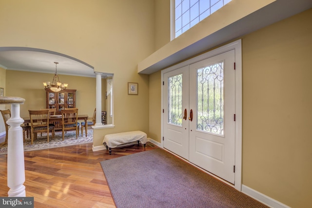 18 Knottingham Dr, Voorhees, NJ 08043 - foyer entrance with decorative columns, arched walkways, wood finished floors, healthy amount of natural light, and a high ceiling